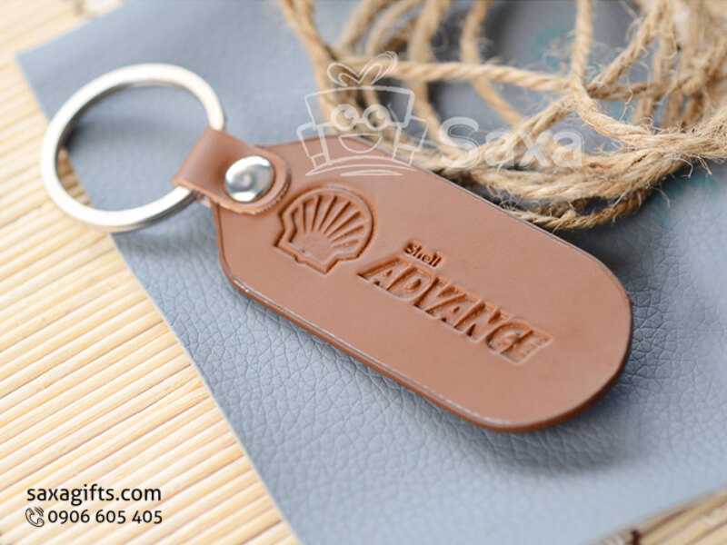 Leather keychain in brown with a metal board