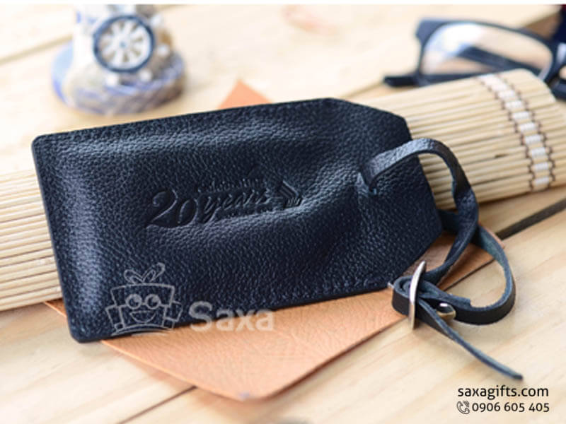 Luggage tag from rough black leather and horizontal cap